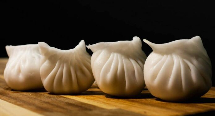 Four soup dumplings on a table