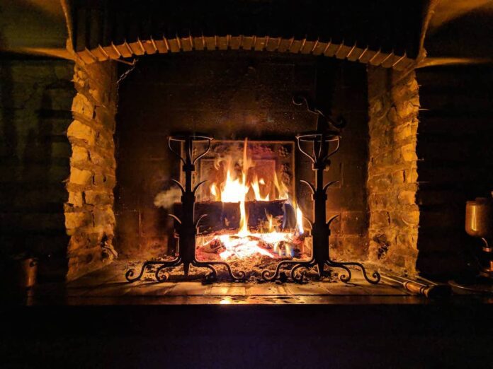 Brick fireplace with an active fire burning