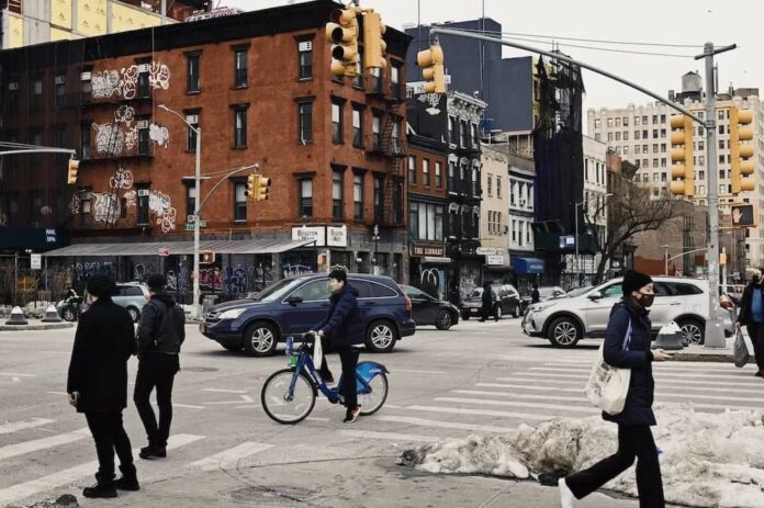 Pedestrians and cars on a busy New York street