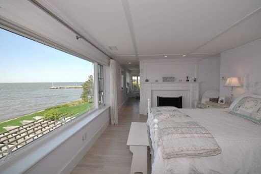Bedroom with fireplace and view waterfront