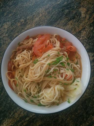 Image of noodles with tomatoes, scallion, and beef soup