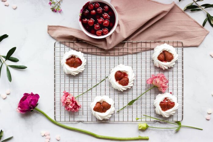 Image of cookies and strawberries on a cooling rack