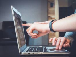 Finger pointing at laptop screen