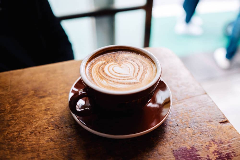 A cup of coffee sitting on table