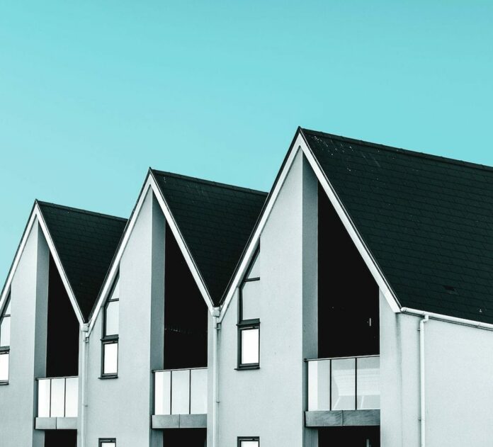 Row of black and white houses against blue background