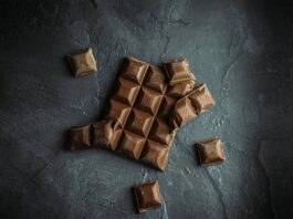 A broken chocolate bar on dark table