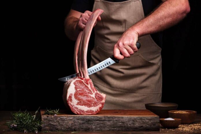 Man slicing a steak
