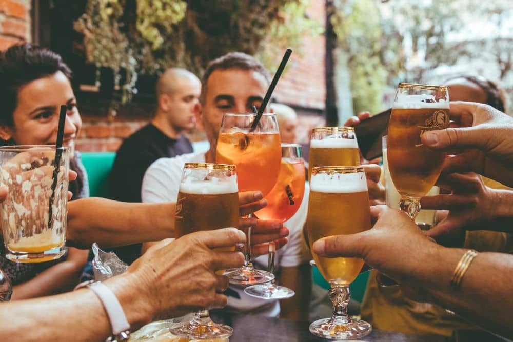 People around a table clinking their glasses together