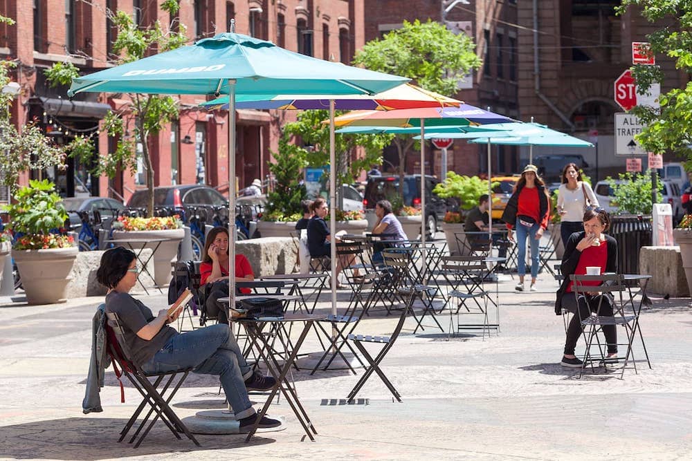 New Yorkers sitting in Pearl Street Triangle in Dumbo