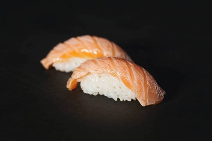 Pieces of nigiri on a black surface