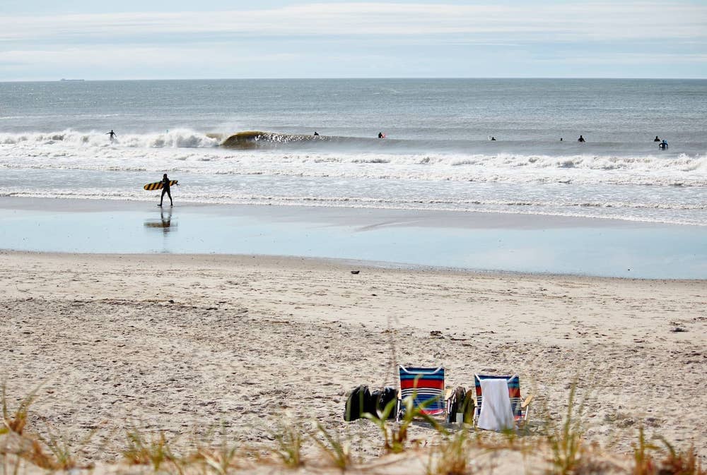 A surfer at Rockaways Beach